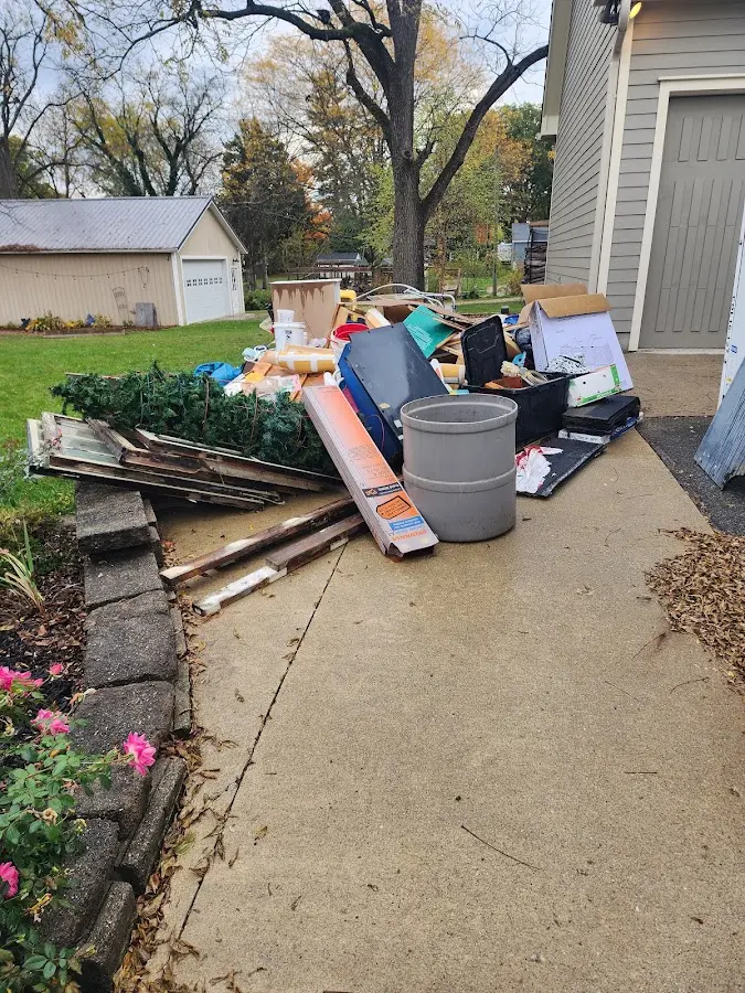 Dumpster being loaded with debris for 10 Yard Dumpster Rental in Timberlane